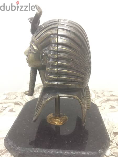 a copper mask of tutankhamun 5