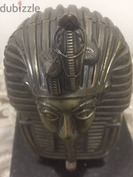 a copper mask of tutankhamun 7