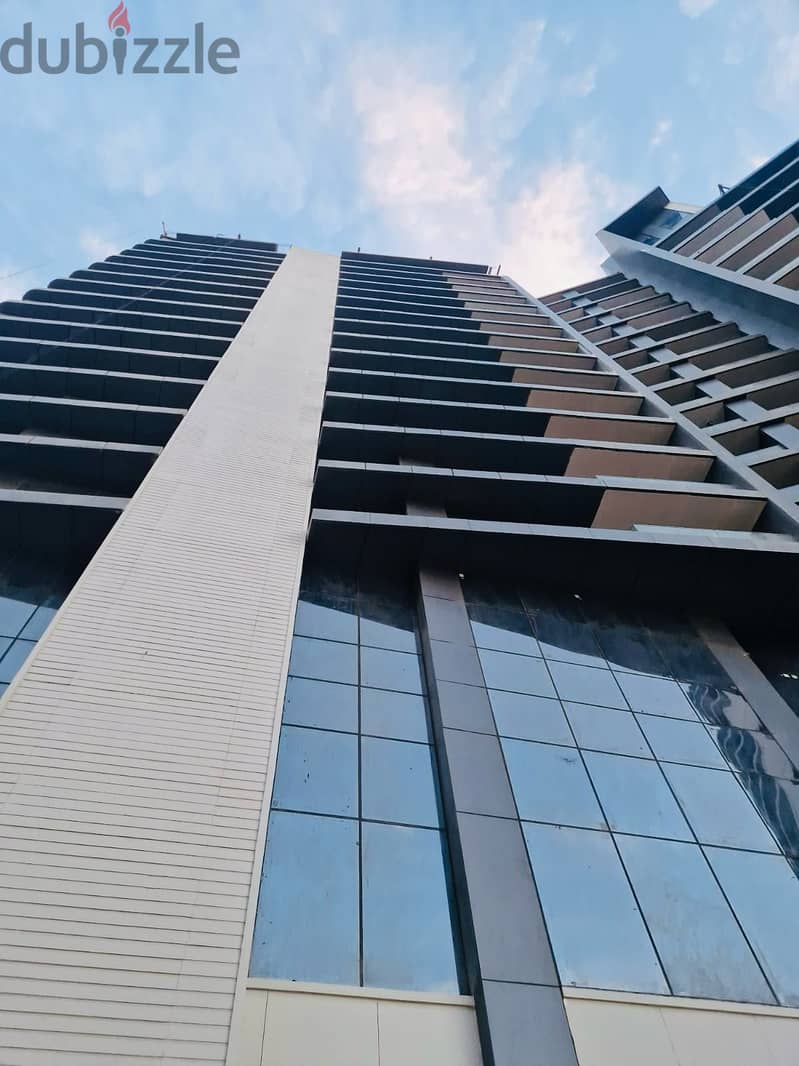 3-bedroom apartment, finished, with air conditioners and kitchen cabinets, for sale in the first towers in the Fifth Settlement, minutes from the AUC 7