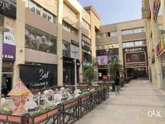 A commercial store for sale in installments, 152 square meters, first floor in Exit 14 Mall, in front of Greens Compound