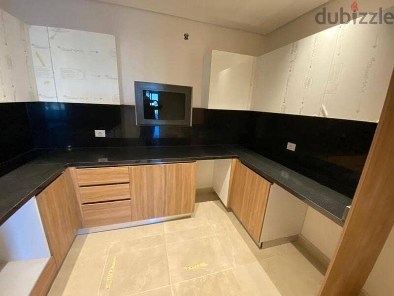 3-bedroom apartment, finished, with air conditioners and kitchen cabinets, for sale in the first towers in the Fifth Settlement, minutes from the AUC 4