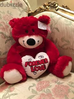 red fluffy bear with a heart (brand new) never used before.