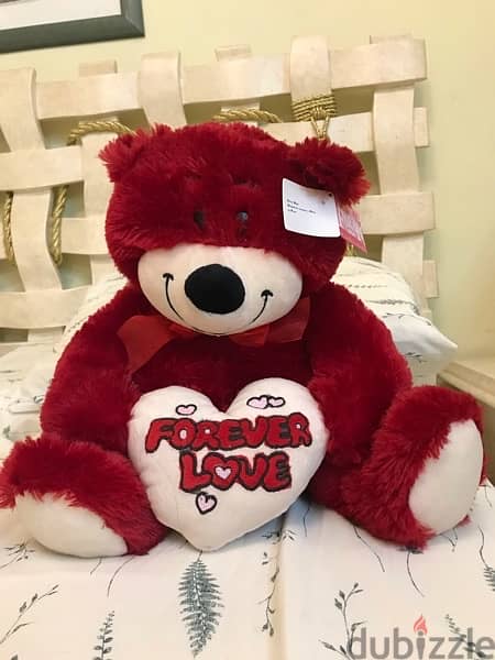 red fluffy bear with a heart (brand new) never used before. 1