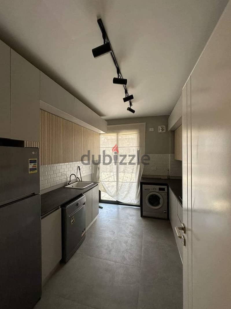 For sale, an apartment with a garden, in installments, finished with air conditioning, in Amaze Location, Sheikh Zayed, from Dorra in Village West. 2