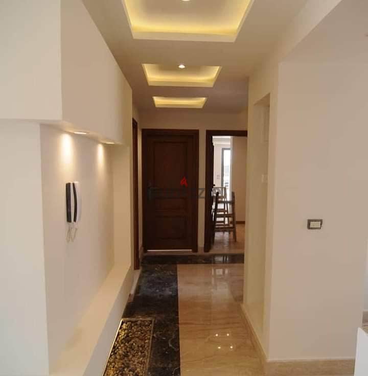 A luxury apartment for sale in installments in a very special location, with a landscape in the Taj City Compound, in front of Cairo International Air 2