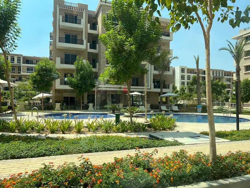 In front of Cairo Airport and Mirage City, a distinctive apartment with a clear sea corner, 166 square meters, for sale in Taj City Compound, New Cair 4