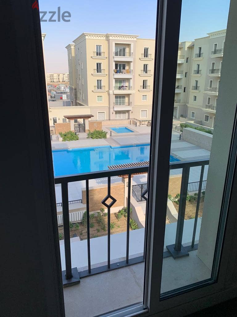 semi furnished Apartment 2rooms for rent in Mivida Boulevard  view pool 12