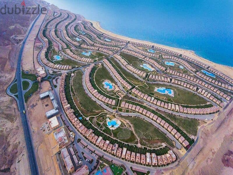Sky chalet for sale, “3 rooms + maid’s room,” view lagoon in Telal Ain Sokhna village, next to Porto, fully finished, in installments 18