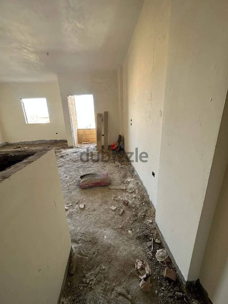 Semi-finished apartment in Al-Fardous City, in front of Dreamland 1