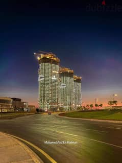 For sale, a 150 sqm apartment, fully finished + ACs, in Al Alamein Towers, North Coast, with a 15% down payment 0