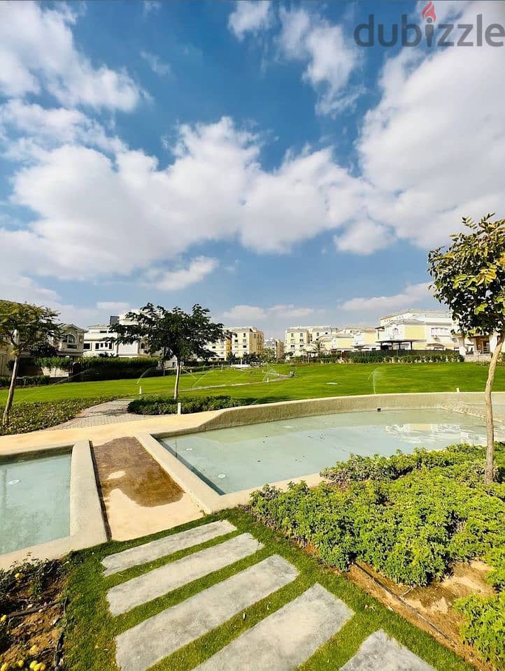 An apartment with a distinctive garden, immediate receipt, with a 15% down payment, in the heart of the Fifth Settlement 2