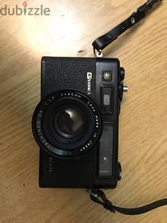 Yashica electro 35 GTN camera black colored and Raynox flash