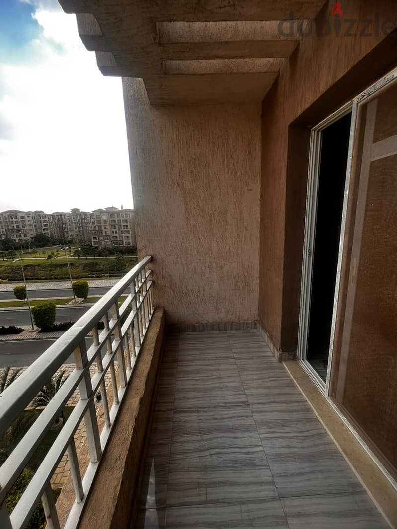 An apartment with special finishes and a garden view in a prime location in B7, Madinaty 9