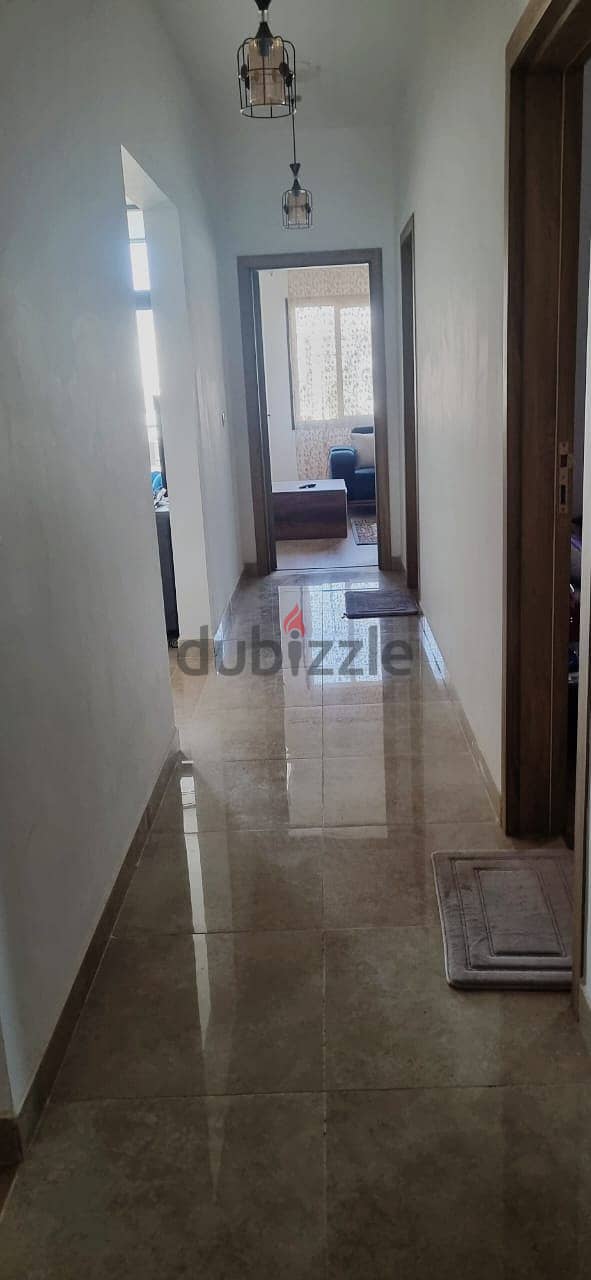 For sale, an apartment with ready to move finished, with air conditioners and kitchen, with a down payment and installments, in Fifth Square 12