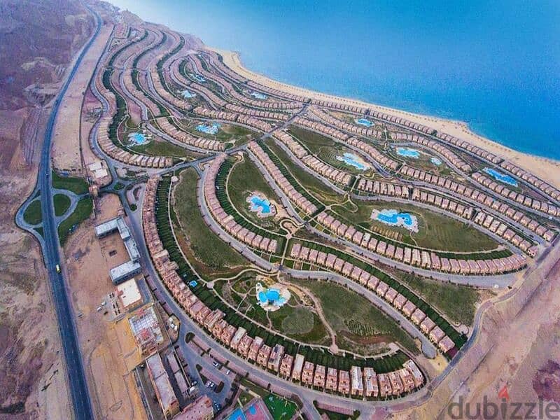 Sky chalet for sale, “3 rooms + maid’s room,” view lagoon in Telal Ain Sokhna village, next to Porto, fully finished, in installments 18