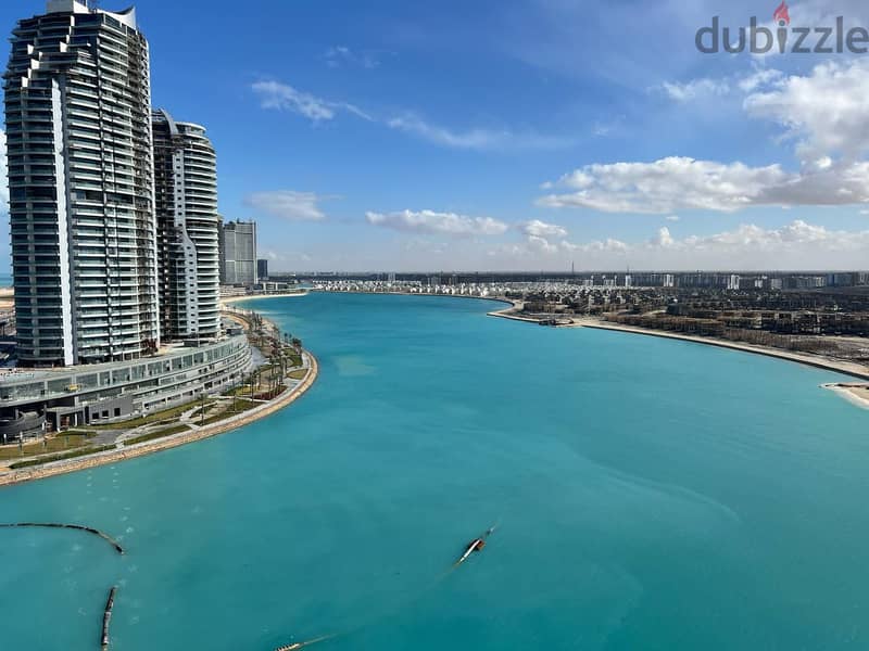 I own an apartment in New Alamein Towers with a panoramic view of the sea and the beach with only 10% down payment 9