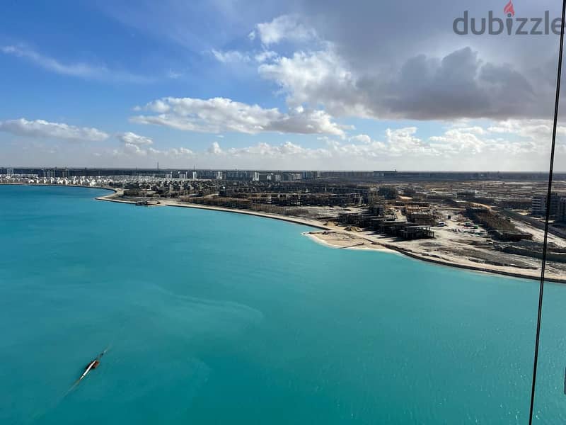 I own an apartment in New Alamein Towers with a panoramic view of the sea and the beach with only 10% down payment 12