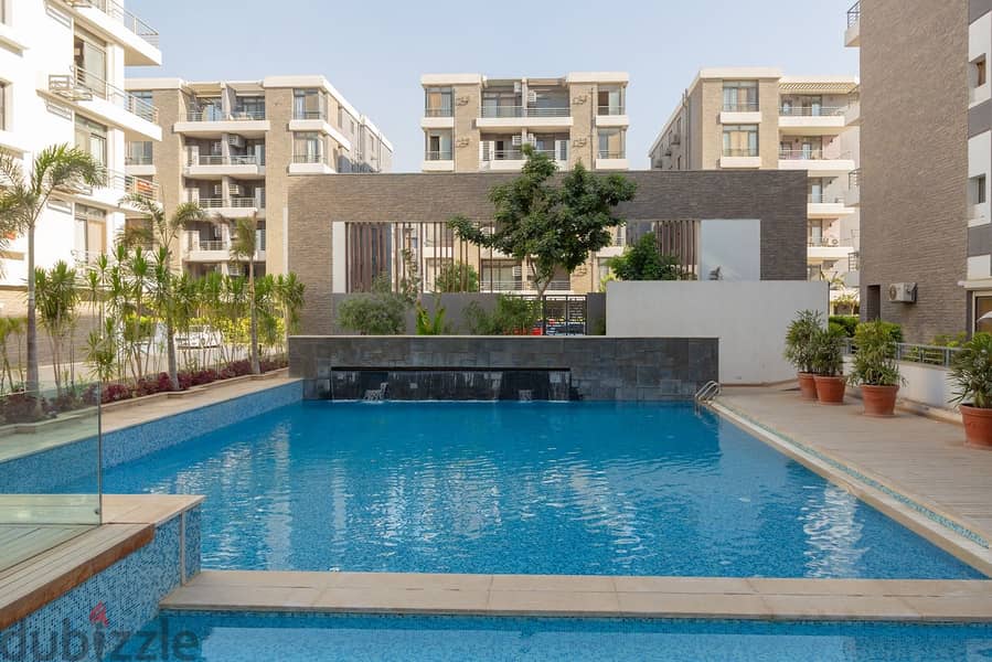 An apartment with a private garden in Taj City Compound, a distinctive location, with a 10% down payment over 8 years, an area of 130 m, a garden 45 2