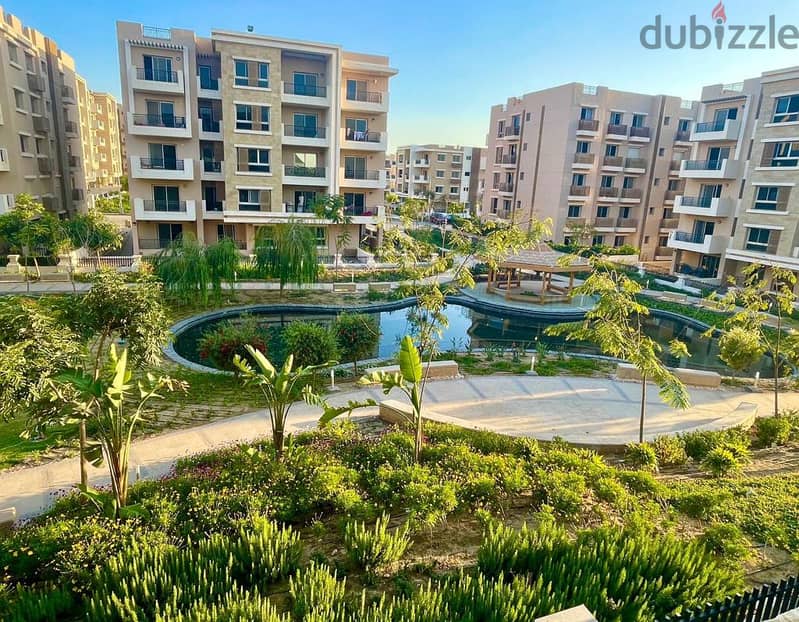 An apartment with a private garden in Taj City Compound, a distinctive location, with a 10% down payment over 8 years, an area of 130 m, a garden 45 6