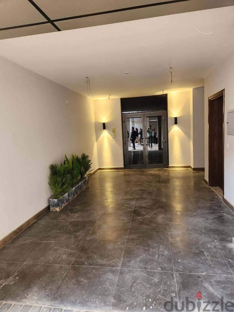 Apartment for sale in Zed Towers, luxuriously finished, ACs and kitchen, in a strategic location in Sheikh Zayed, next to Al Rabwa 9