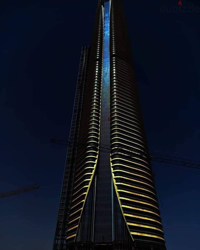 A finished office in a skyscraper, first row, in front of the entrance to the iconic tower and the Green River, and next to the monorail station in th 7
