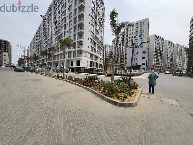 Apartment for sale, 100 meters, with a private garden of 15 meters, completed in installments, in One Katameya Compound 10