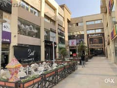 A commercial store for sale in installments, 152 square meters, first floor in Exit 14 Mall, in front of Greens Compound