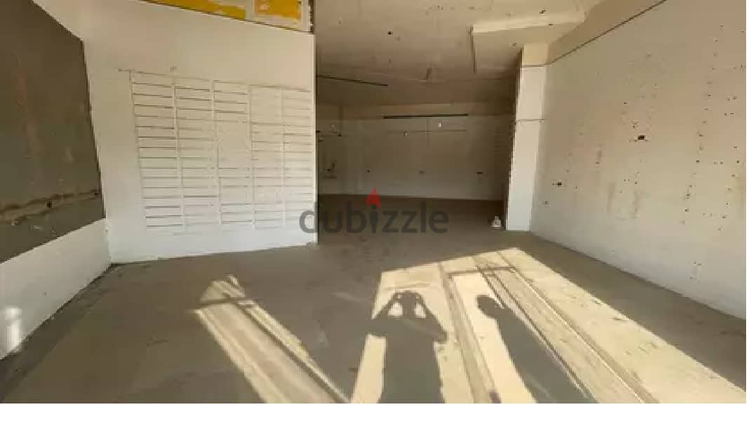 A snapshot of a commercial ground floor shop for sale (51 m + 33 m outdoor), facing directly on the desert road in Sheikh Zayed, in front of Sphinx Ai 3