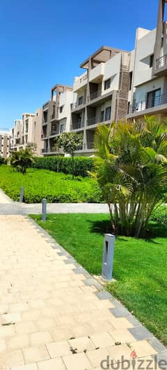 Apartment for sale with private garden, fully finished, with air conditioners and ready to move with an open view and landscape