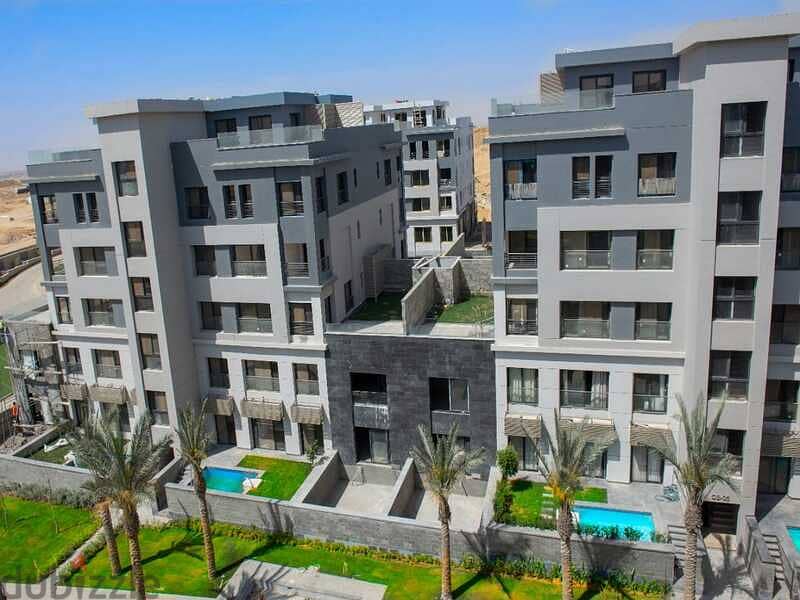 With only 5% down payment, an apartment with a garden of 155 meters in Trio Gardens Compound, with a 40% cash discount, with a view on the landscape 11