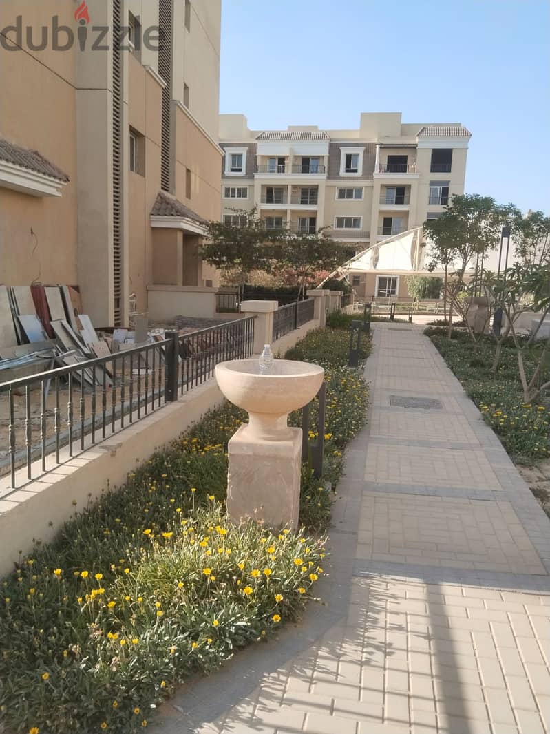 Two rooms, 105 sqm, ground floor, 68 sqm garden, for sale in Sarai Compound on Suez Road, intersection with Al Amal Axis, with a 10% down payment and 13