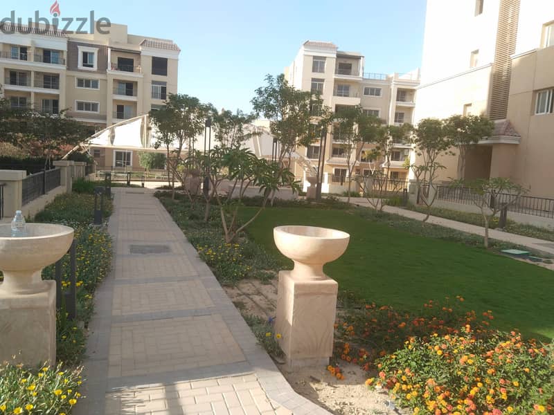 Two rooms, 105 sqm, ground floor, 68 sqm garden, for sale in Sarai Compound on Suez Road, intersection with Al Amal Axis, with a 10% down payment and 14