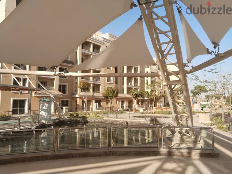 Two rooms, 105 sqm, ground floor, 68 sqm garden, for sale in Sarai Compound on Suez Road, intersection with Al Amal Axis, with a 10% down payment and 18