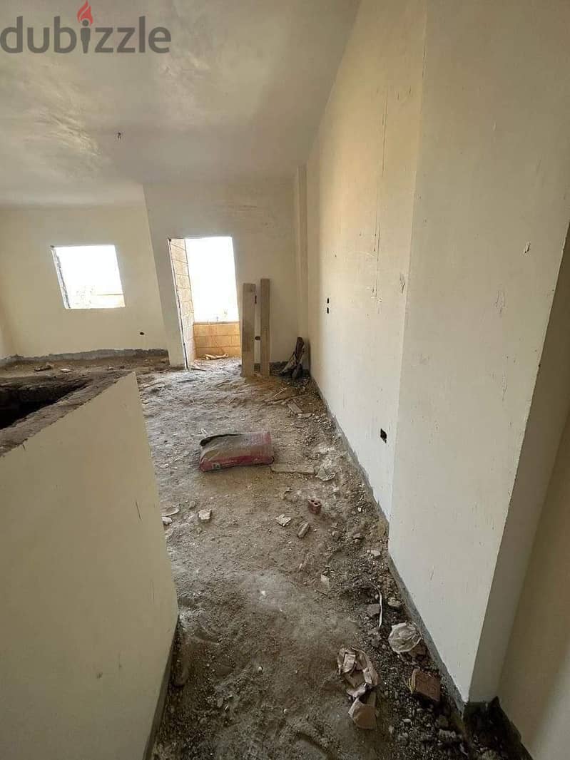 Semi-finished apartment in Al-Fardous City, in front of Dreamland 1