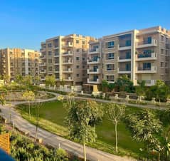 Ground floor apartment with garden for sale in Taj City Direct Compound on Suez Road in front of Kempinski Hotel