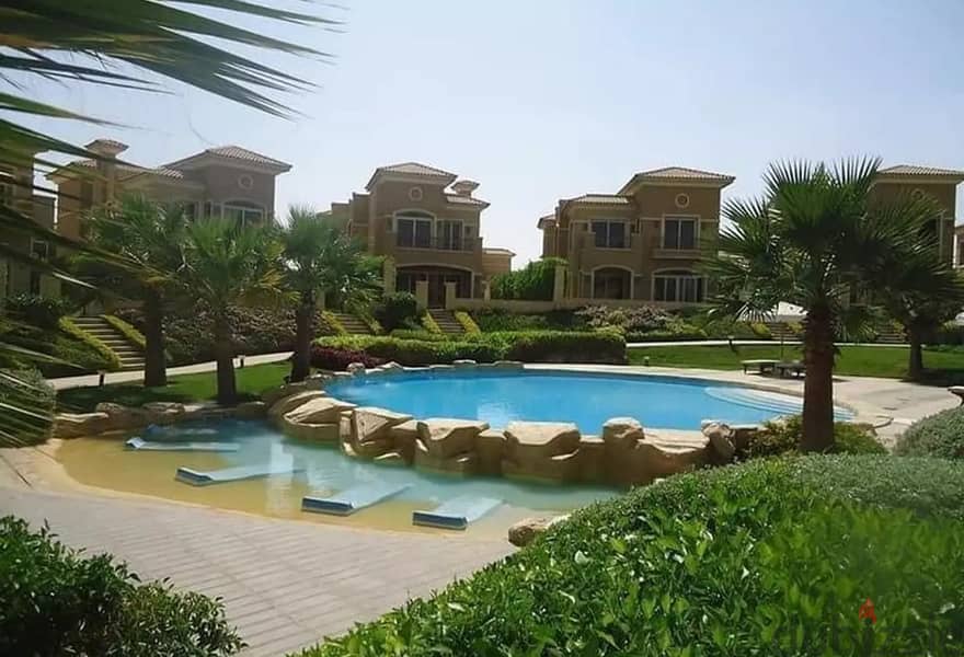Stone villas for sale in Stone Park Compound with a landscaped view and water features 3