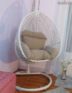 Rattan swing chair with pillows