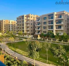 Ground floor apartment with garden for sale in Taj City Direct Compound on Suez Road in front of Kempinski Hotel