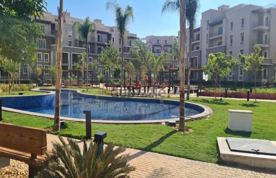 For quick sale, an apartment with a garden, immediate receipt, fully finished, with air conditioners and a kitchen, in October Plaza Compound 5