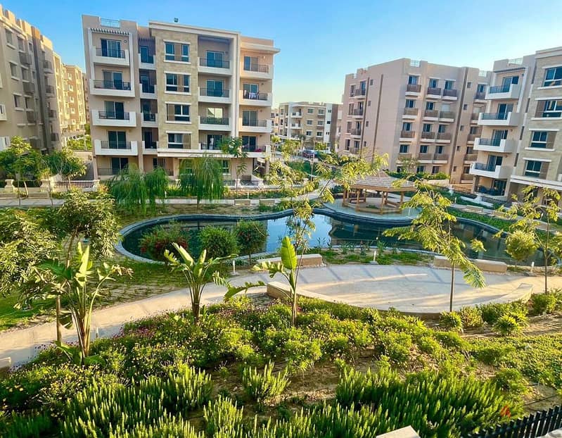 An apartment with a garden for sale with a down payment of 1,255,000 in a prime location in El Tagamoa 2