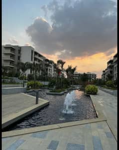 Apartment 165. M with garden 110. M in The Address East New Cairo fully finished with kitchen cabinets overlooking landscape and water features for sale