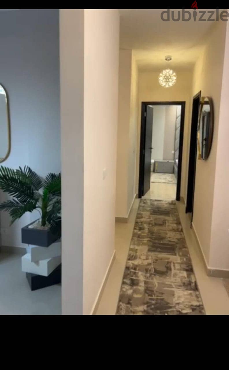 Apartment 165. M with garden 110. M in The Address East New Cairo fully finished with kitchen cabinets overlooking landscape and water features for sale 1