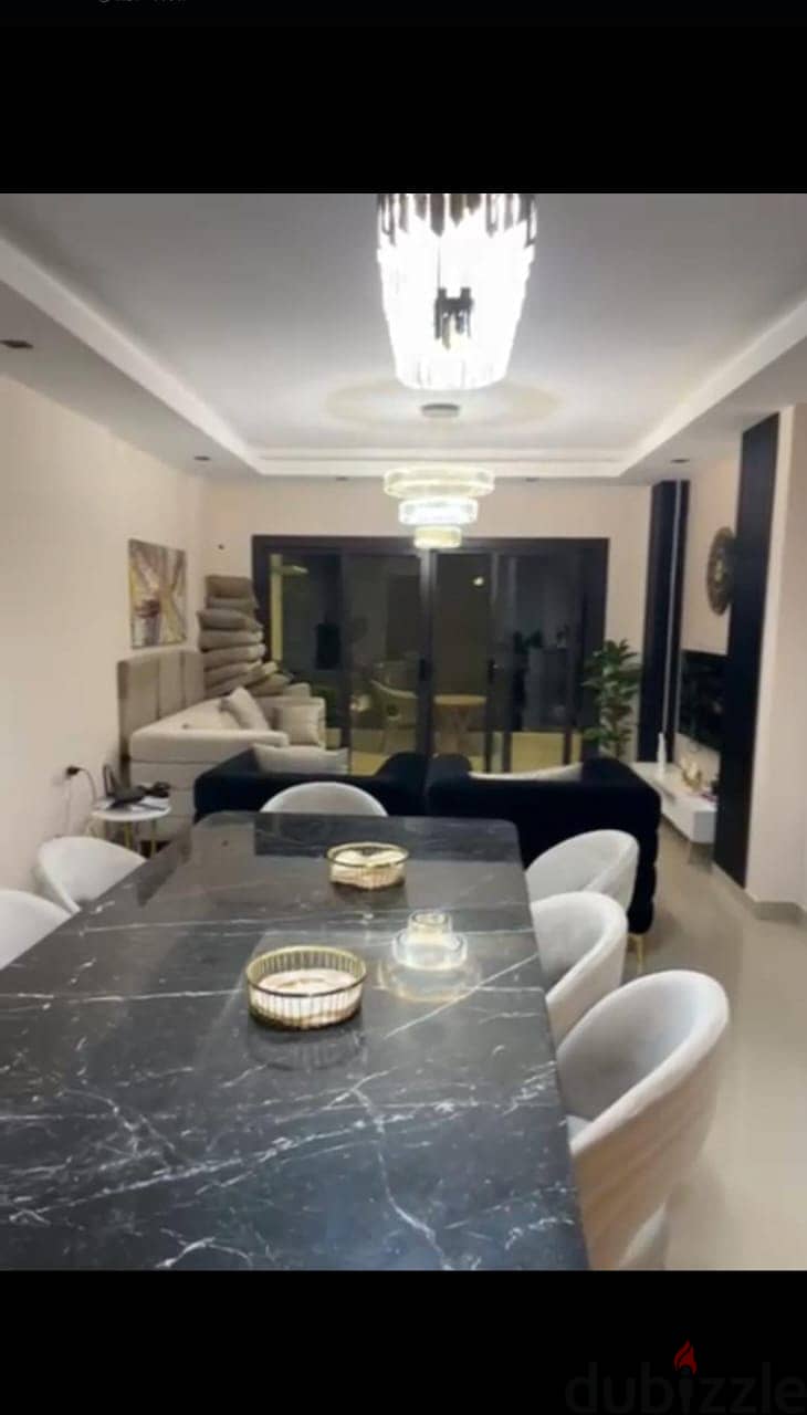 Apartment 165. M with garden 110. M in The Address East New Cairo fully finished with kitchen cabinets overlooking landscape and water features for sale 8