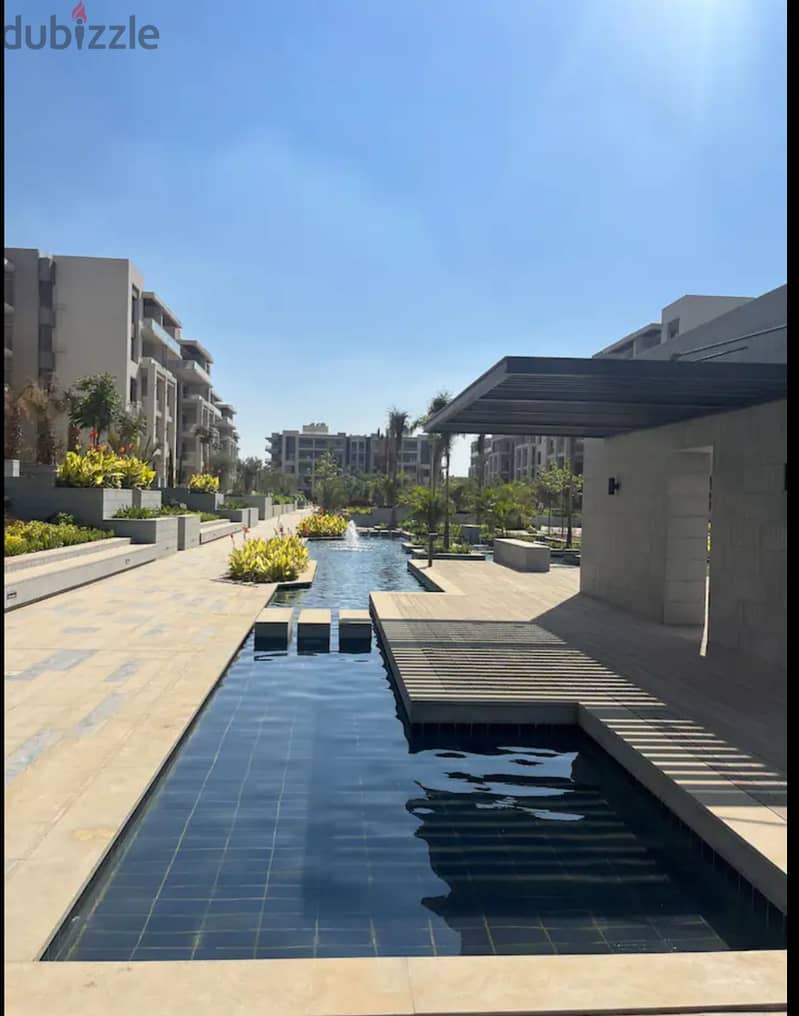 Apartment 165. M with garden 110. M in The Address East New Cairo fully finished with kitchen cabinets overlooking landscape and water features for sale 9