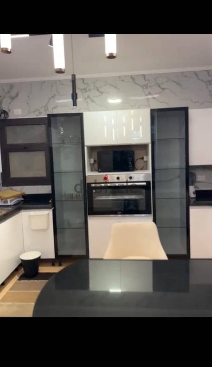Apartment 165. M with garden 110. M in The Address East New Cairo fully finished with kitchen cabinets overlooking landscape and water features for sale 11