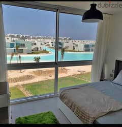 With a 5% down payment, a hotel chalet for sale, finished with appliances, first row on the sea, in Fouka Bay, Ras El Hekma, North Coast