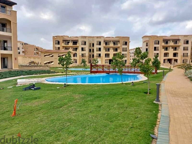 For a snapshot price, I own an apartment with a garden in the best location in the settlement on the Maadi Ring Road Stone Park 1