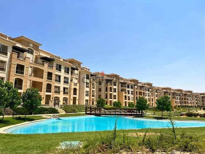 With the best location, own an apartment with a roof, 123 m, receipt for 6 months, in Stone Residence, New Cairo 2