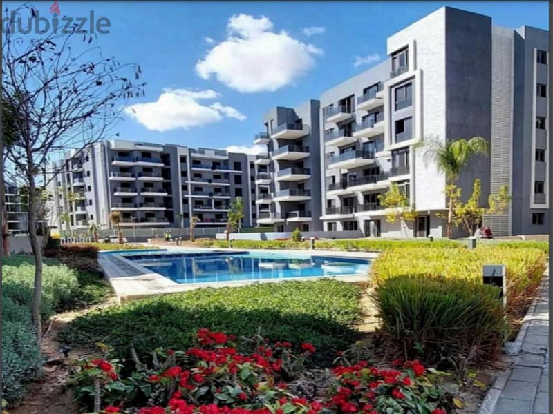 Ground apartment with a private garden, immediate receipt, in Sun Capital, the heart of October, with a 10% down payment and equal installments 9