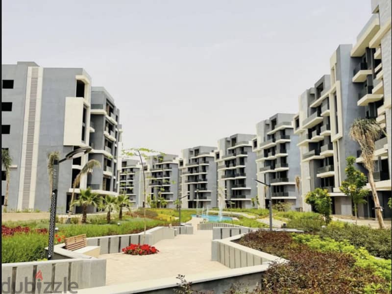 Ground apartment with a private garden, immediate receipt, in Sun Capital, the heart of October, with a 10% down payment and equal installments 15